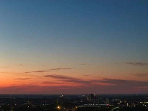 A Stunning Sunset Casts Its Glow Over the Urban Skyline, Creating a Beautiful Stock Photos