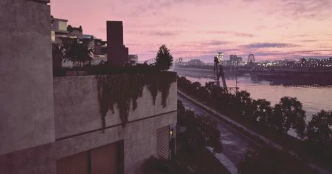 A stunning sunset casts vibrant colors across the sky over an urban riverbank Ilustração Stock