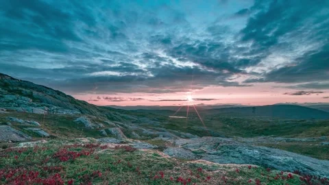 A stunning sunset in the dark stormy sky over a rocky tundra landscape, Vídeos de archivo 280691785