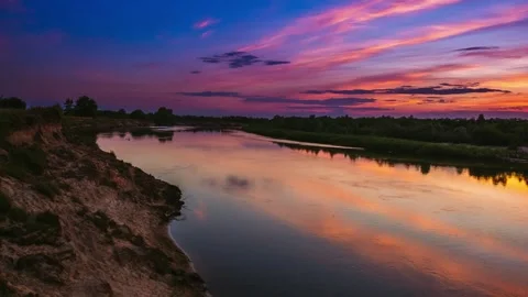A Stunning Sunset Displaying Over a Tranquil River, Featuring Beautiful Stock Footage 280548264