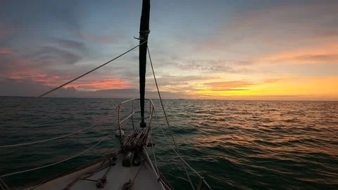Stunning sunset looking over the bow of a sailboat Stock Footage 163813506