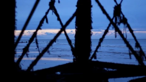 Stunning Sunset Ocean Waves Through Silhouette of Steel Pier Girders Vídeo Stock 94476192