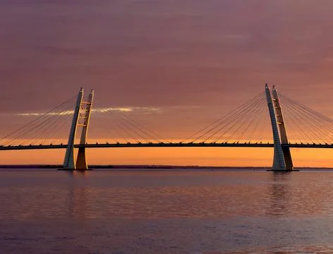 Stunning Sunset over Cable-Stayed Bridge and Calm Waters Stock Photos