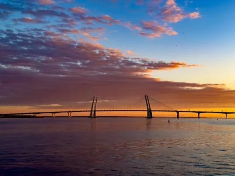 Stunning Sunset over Cable-Stayed Bridge and Calm Waters Stock Photos