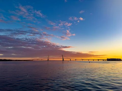 Stunning Sunset over Cable-Stayed Bridge and Calm Waters Stock Photos