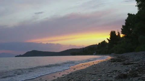 Stunning Sunset Over Calm Beach with Driftwood Stock Footage 328108518