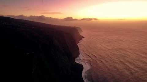 Stunning sunset over dramatic coastline with waves crashing below Stock Footage 304751890