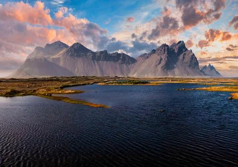 Stunning sunset over the dramatic peaks of Vestrahorn mountain and black sand Stock Photos