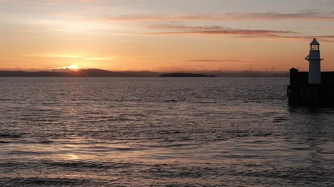 Stunning sunset over Firth of Forth with lighthouse view Stock Footage 302119751