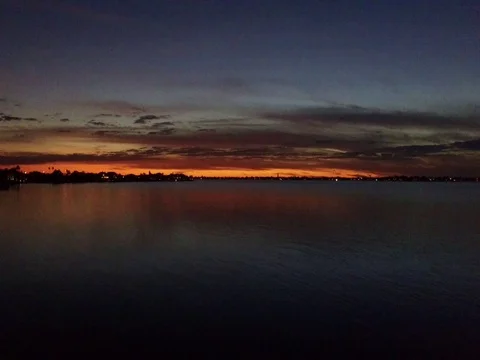 Stunning sunset over gulf of mexico, pan, island, water Stock Footage