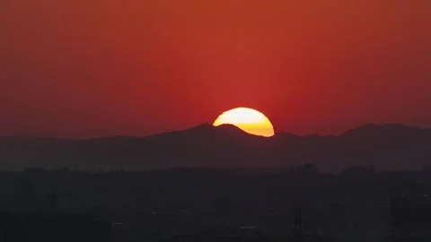 Stunning sunset over the mountain range with a vibrant orange sky Stock Footage 341939962