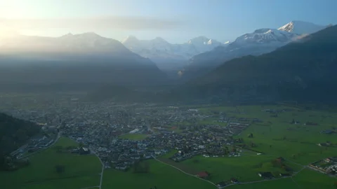 Stunning sunset over mountain. Surrounded town in the valley. Interlaken Stock Footage 246084199