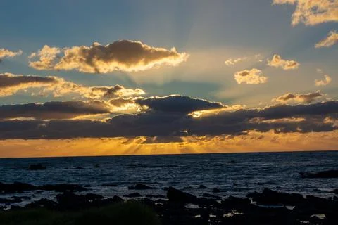 Stunning Sunset Over the Ocean with Rays of Light Stock Photos