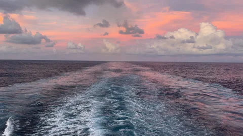 Stunning Sunset Over the Open Ocean with Ship's Wake Stock Footage 297852919