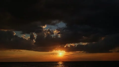 Stunning sunset over the sea with sunbeam and dramatic clouds. Video stock 249780897