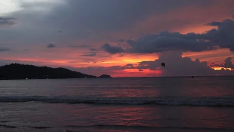Stunning sunset over a tranquil beach showcasing vibrant colors of nature. Stock Footage 324108358