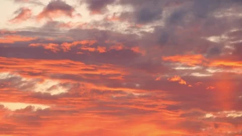 A stunning sunset sky with fluffy clouds and warm colors that inspire awe and Stock Footage 283701480