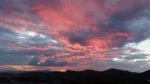 Stunning sunset sky with vibrant pink and orange clouds over mountains Stock Footage 341908344