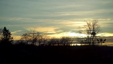 Stunning sunset with treeline silouette while travelling Video stock 263816120