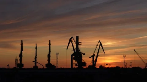 A stunning sunset view of cranes at the harbor Stock Footage 260445931
