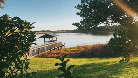 Stunning Sunset View with Dock on Peaceful Lake Stock Footage 295663723