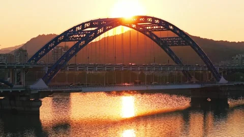 Stunning sunset view over bridge and river with mountains in the background Stock Footage 310501522