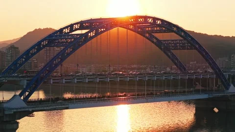Stunning sunset view over bridge and river with mountains in the background Video stock 313582964