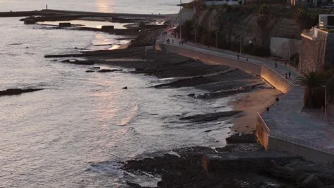 Stunning sunset view over coastal rocks at seaside promenade in Cascais Portugal Stock Footage 290008469