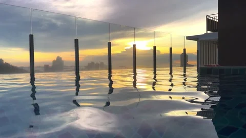 Stunning sunset view from a pool overlooking a city skyline with skyscrapers and Stock Footage 304881041