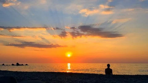 Stunning time lapse at sunset beach with family chilling and orange sky. Stock Footage 126094466