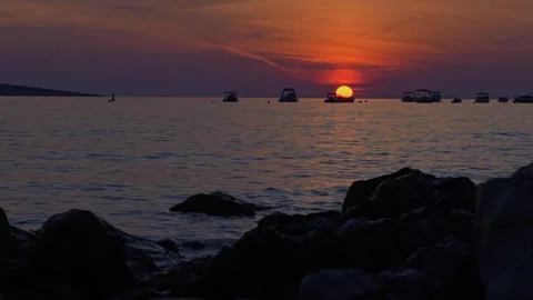 Stunning time-lapse of vibrant sunset over calm sea Stock Footage 298564627