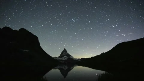 Stunning timelapse of the night sky over the iconic Matterhorn peak in the Swiss Stock Footage 312278997