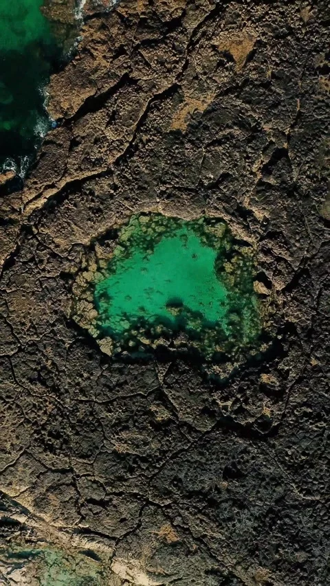 Stunning top-down aerial view slowly revealing a vibrant natural pool with Stock Footage 344843741
