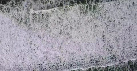 Stunning Top-Down View of Ocean Waves Breaking on a Sandy Beach Stock Photos