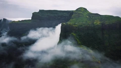 Stunning Top View of Green Mountains with Fog and Smoke Underneath Stock Footage 287747486