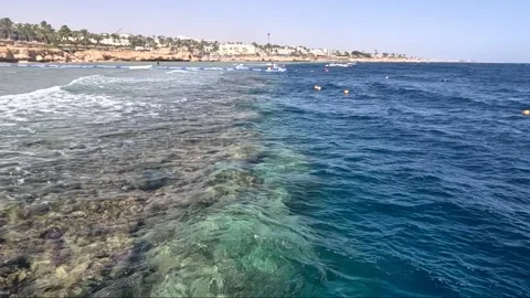 A Stunning Transition of Colors: The Merging of Vibrant Shallow Waters and Deep Stock Footage 330102859