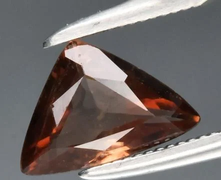 Stunning Triangular Cut Brown Gemstone Glimmering with Light Reflections 写真素材