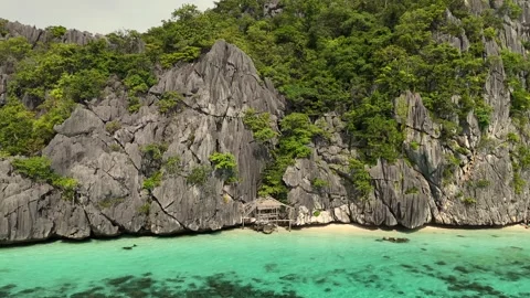 Stunning Tropical Beach with Limestone Cliffs and Crystal-Clear Water Stock Footage 295792270