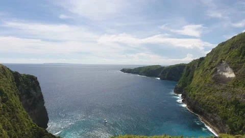 Stunning tropical view, huge cliffs along the coastline, ocean and mountains, 4k Stock Footage 136805635