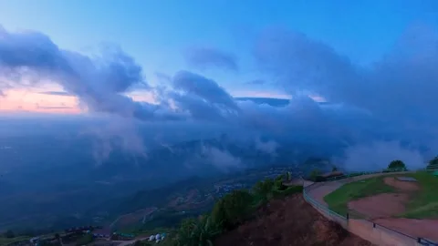 A stunning twilight scene with rolling clouds over mountains, casting a ser.. Stock Footage 278239141
