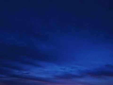 Stunning twilight sky, deep blue hues with subtle cloud formations. Perfect f Stock Photos