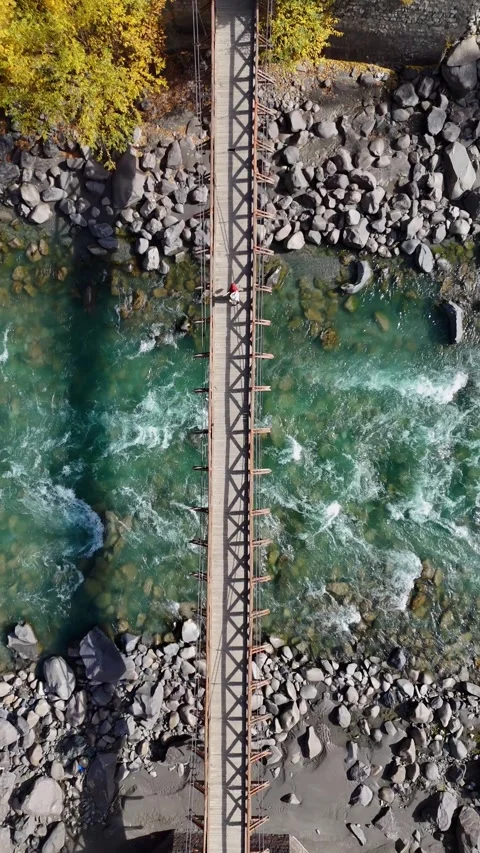 Stunning vertical drone shot over vintage wooden bridge during autumn in Kargil. Stock Footage 310664709