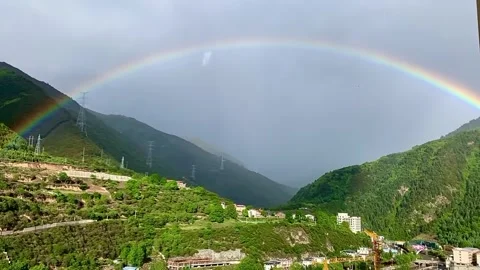 Stunning Vibrant Rainbow Arching Over Lush Green Mountain Valley Landscape Stock-Footage 337460891