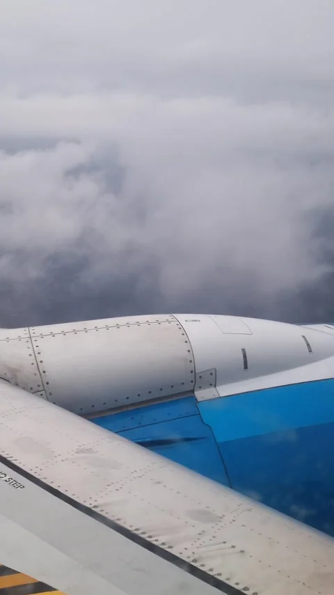Stunning view from an airplane window showing the wing and engine while flying Video stock 327134115