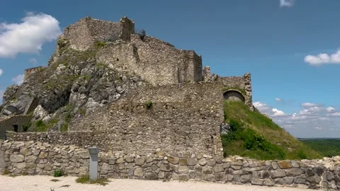 A stunning view of an ancient stone castle atop a rocky hill Stock Footage 301648232