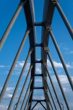 A Stunning View of Architectural Elements Underneath a Bridge Against a Cle.. Stock Photos