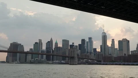A stunning view of the Brooklyn Bridge against the backdrop of a vibrant city Stock Footage 316512295