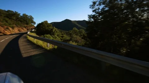 Stunning view from car window, driving on a serpentine road. Great view on Stock Footage 98457673