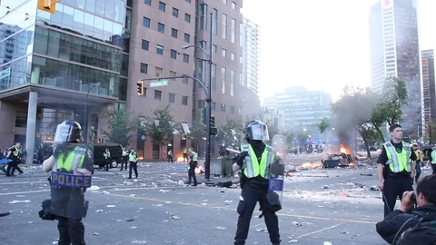 Stunning view of city in disarray with fires burning and cops on horses Stock Footage 127196504