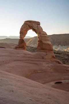 A stunning view of Delicate Arch during sunrise on a cool October morning. Stock Photos